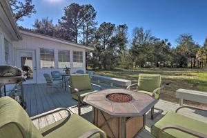a patio with a table and chairs and a grill at Hilton Head Golfers Getaway Waterfront Location! in Hilton Head Island