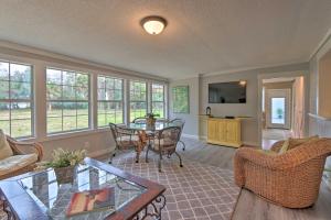 a living room with a table and chairs at Hilton Head Golfers Getaway Waterfront Location! in Hilton Head Island
