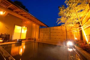 a house with a swimming pool at night at Kappo Ryokan Kannawa Bettei in Beppu +30 photos