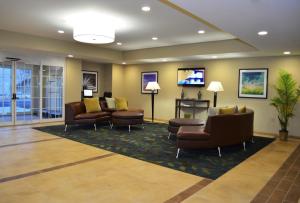 a lobby with couches and chairs in a hospital at Candlewood Suites Greenville, an IHG Hotel in Greenville