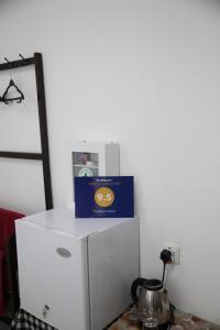 a white refrigerator with a box on top of it at The Dream Resort in Ella