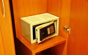 a microwave sitting on a shelf in a room at Baan SS Karon in Karon Beach