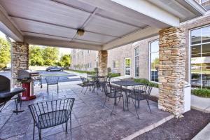 a patio with tables and chairs and a grill at Candlewood Suites Indianapolis Airport, an IHG Hotel in Indianapolis