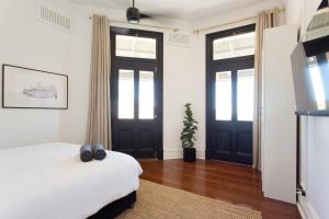 
a room with a bed and a window at SoBe Fremantle in Fremantle
