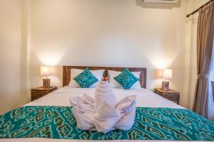Postel nebo postele na pokoji v ubytování Darba Guest House Ubud
