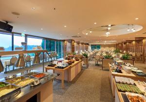 a buffet line with food on display in a restaurant at Kirishima Hotel in Kirishima