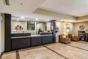 a lobby with a woman in a waiting room at Candlewood Suites Jacksonville East Merril Road, an IHG Hotel in Jacksonville