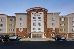 a large building with cars parked in a parking lot at Candlewood Suites Smyrna - Nashville by IHG in Smyrna
