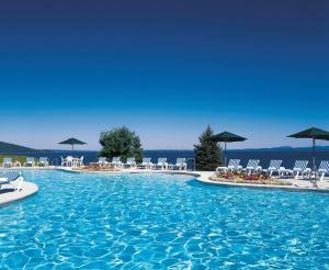 a beach with a pool and a beach chair at Holiday Inn Bar Harbor Regency Hotel, an IHG Hotel in Bar Harbor