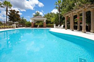 a large blue swimming pool with a gazebo at Candlewood Suites Lake Mary, an IHG Hotel in Lake Mary