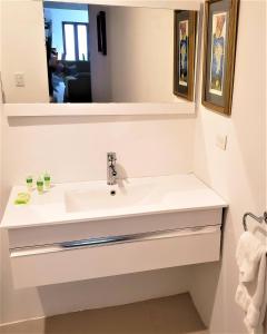 a bathroom with a sink and a mirror at KASA The Lofts 202 HUGE 2 Bed 2 bath Washer Dryer in San Juan