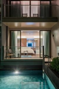 a view of a hotel room with a swimming pool at Oceanfront Beach Resort - SHA Extra Plus in Patong Beach