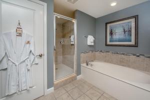 a bathroom with a bath tub and a shower at Holiday Inn Club Vacations Sunset Cove Resort in Marco Island