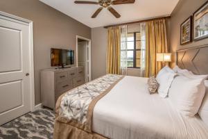 a bedroom with a large bed and a television at Holiday Inn Club Vacations Sunset Cove Resort in Marco Island