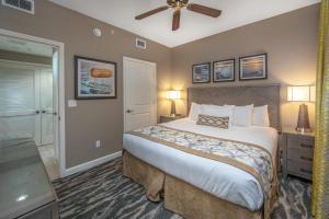 a bedroom with a large bed and a ceiling fan at Holiday Inn Club Vacations Sunset Cove Resort in Marco Island