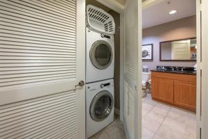 a laundry room with two washer and dryer at Holiday Inn Club Vacations Sunset Cove Resort in Marco Island