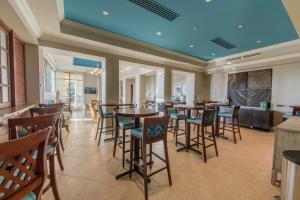 a restaurant with tables and chairs and a blue ceiling at Holiday Inn Club Vacations Sunset Cove Resort in Marco Island