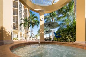 a swimming pool with a fountain in a building at Holiday Inn Club Vacations Sunset Cove Resort in Marco Island