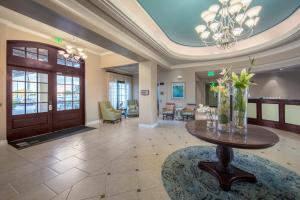 a lobby with a table with flowers on it at Holiday Inn Club Vacations Sunset Cove Resort in Marco Island