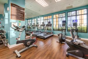 a gym with several treadmills and elliptical machines at Holiday Inn Club Vacations Sunset Cove Resort in Marco Island