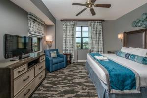 a hotel room with a bed and a television at Holiday Inn Club Vacations Sunset Cove Resort in Marco Island