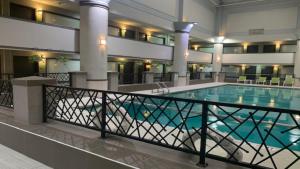 a large swimming pool in a hotel lobby at Holiday Inn Chicago North Shore by IHG in Skokie