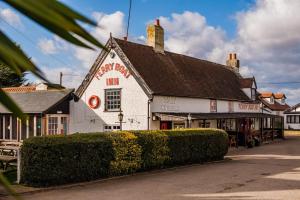 a white building with a red sign on it at The Lookout in Felixstowe