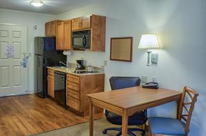 a kitchen with a refrigerator, stove, sink and a microwave at Candlewood Suites Mobile-Downtown, an IHG Hotel in Mobile