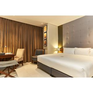 A bed or beds in a room at Summit Hotel Tacloban