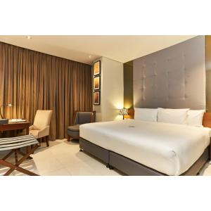 A bed or beds in a room at Summit Hotel Tacloban