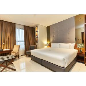 A bed or beds in a room at Summit Hotel Tacloban