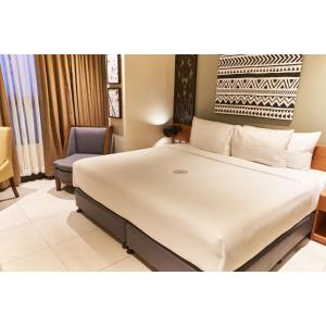 A bed or beds in a room at Summit Hotel Tacloban