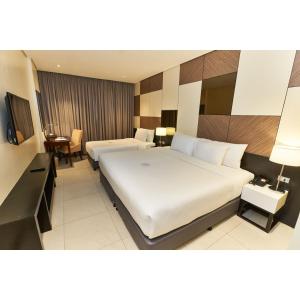 A bed or beds in a room at Summit Hotel Tacloban