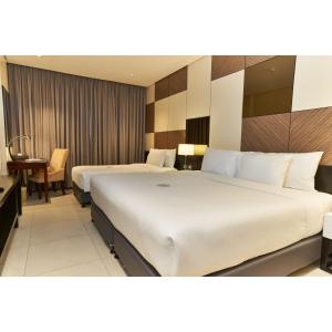A bed or beds in a room at Summit Hotel Tacloban