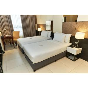A bed or beds in a room at Summit Hotel Tacloban