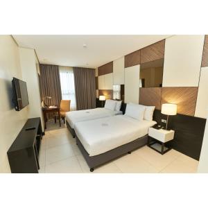 A bed or beds in a room at Summit Hotel Tacloban