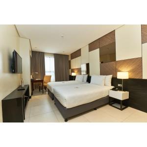 A bed or beds in a room at Summit Hotel Tacloban