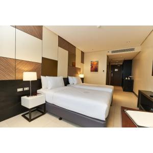 A bed or beds in a room at Summit Hotel Tacloban