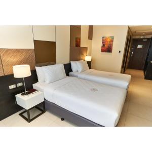 A bed or beds in a room at Summit Hotel Tacloban