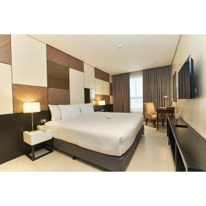 A bed or beds in a room at Summit Hotel Tacloban