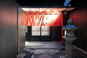 an entrance to a building with a red curtain at Wa no Kaede in Tokyo