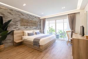 a bedroom with a bed and a brick wall at VAYNA Boutique Koh Chang in Ko Chang +75 photos