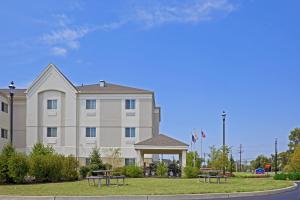a large building with picnic tables in front of it at Candlewood Suites Bordentown-Trenton, an IHG Hotel in Bordentown