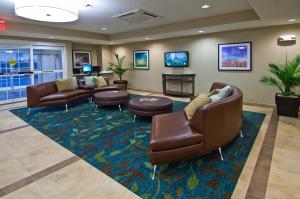 a waiting room with couches and chairs in a lobby at Candlewood Suites Tupelo by IHG in Tupelo