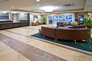 a lobby with a couch and a waiting room at Candlewood Suites Tupelo by IHG in Tupelo
