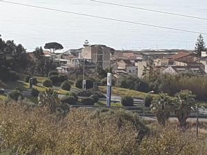 una pintura de una ciudad con casas y árboles en Caccia Apartment, en Santa Teresa di Riva