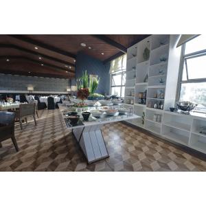 a restaurant with tables and chairs in a room at Summit Ridge Tagaytay in Tagaytay