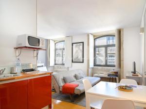 a kitchen and a living room with a couch at Almada Apartments 468 in Porto