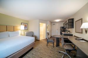 a hotel room with a bed and a desk at Candlewood Suites Washington-Dulles Herndon, an IHG Hotel in Herndon