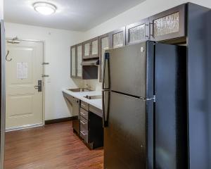 a kitchen with a black refrigerator and a sink at Candlewood Suites Lakeville I-35, an IHG Hotel in Lakeville